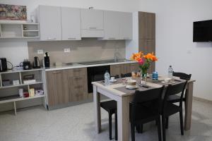a kitchen with a table with chairs and a counter top at Al Giardino b&b in Acri