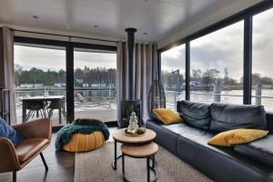 a living room with a couch and a fireplace at Wasservilla freiZeit Usedom in Peenemünde