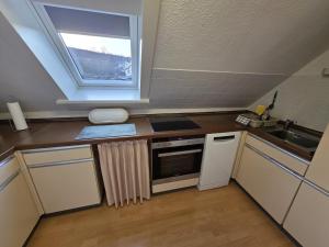 a small kitchen with a sink and a window at EderseeGlück - Fewo 2 in Edertal