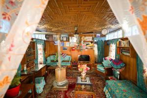 a living room of a train with a table and chairs at Dolphin houseboat in Srinagar