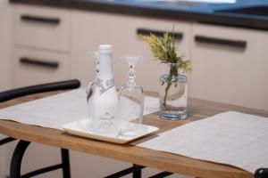 a table with two bottles and a vase on it at Ubytování U Mecha in Bečice