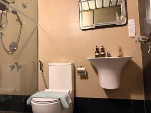 a bathroom with a toilet and a sink at Ace Lagoon View Airport Hotel in Katunayaka