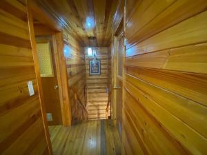 a hallway in a log cabin with wooden walls at Chiloe Seta in Ancud