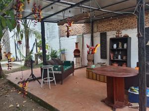 an outdoor patio with a table and a couch at Casa GALLARDO in Danlí