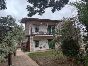 a house with a balcony on top of it at Casa GALLARDO in Danlí