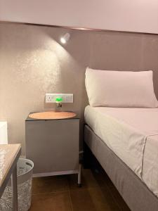 a small bedroom with a bed and a night stand at Ace Lagoon View Airport Hotel in Katunayaka
