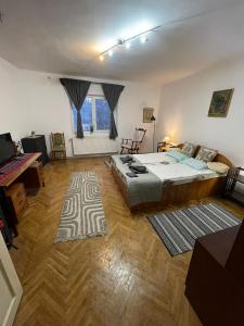 a large bedroom with a bed and a desk at Casa Dalia 1 in Sighişoara