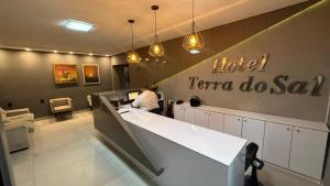 a person sitting at a counter in a hotel karmaosa salon at Hotel Terra do Sal in Mossoró
