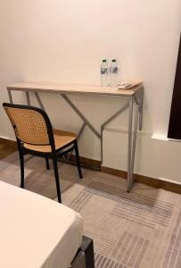 a desk with a chair and water bottles on it at Ace Lagoon View Airport Hotel in Katunayaka