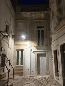 an empty building with two doors and a balcony at Liuzzi ross in Martina Franca +2 photos