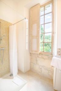 a white bathroom with a shower and a window at Echappée royale in Saint-Benoît-la-Forêt +15 photos
