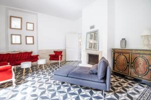 a living room with a couch and a fireplace at Echappée royale in Saint-Benoît-la-Forêt