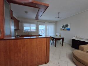 a kitchen with a counter and a table in it at Marbi Apartment in Tripoli