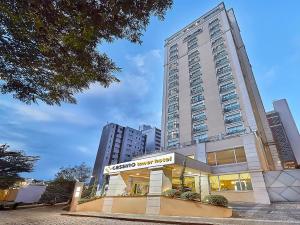 a tall building with a store in front of it at Hotel Cassino Tower Campinas Cambuí By Nacional Inn in Campinas +118 photos