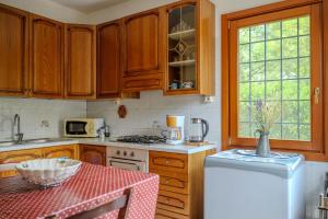 a kitchen with wooden cabinets and a white refrigerator at B&BTorre Cives in Vidracco