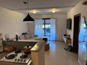 a kitchen and living room with a couch and a stove at Boutique in Rothschild in Rishon LeẔiyyon
