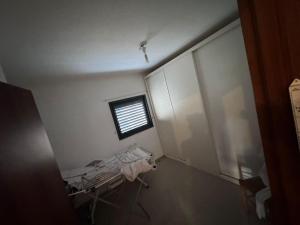 a hospital room with a window and a bed at Boutique in Rothschild in Rishon LeẔiyyon +1 photo