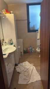 a bathroom with a sink and a towel on the floor at Boutique in Rothschild in Rishon LeẔiyyon