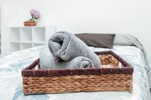 a basket with towels on a bed at Departamento Palmito in La Paz