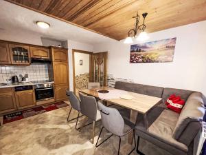 a living room with a table and a couch at Apartment Untererhof-1 by Interhome in Pankrazberg