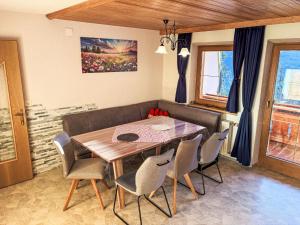 a dining room with a wooden table and chairs at Apartment Untererhof-1 by Interhome in Pankrazberg