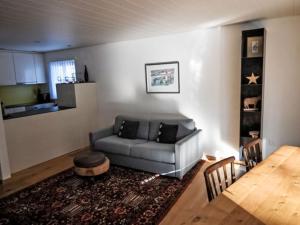 a living room with a couch and a table at Apartment Rustica by Interhome in Lenzerheide