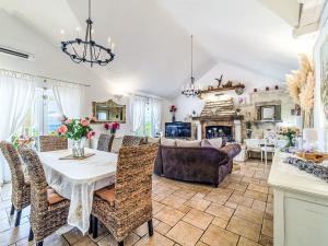 a dining room and living room with a table and chairs at Holiday Home Villa Mutnik by Interhome in Mirce
