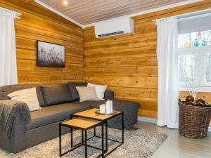 a living room with a couch and a table at Holiday Home Renkitupa by Interhome in Saarenkylä