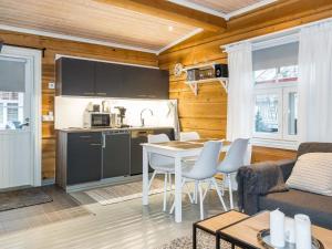 a kitchen and a living room with a table and chairs at Holiday Home Renkitupa by Interhome in Saarenkylä