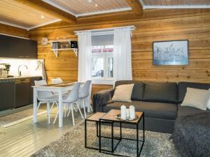 a living room with a couch and a table at Holiday Home Renkitupa by Interhome in Saarenkylä
