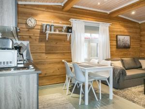 a kitchen and living room with a table and chairs at Holiday Home Renkitupa by Interhome in Saarenkylä +10 photos