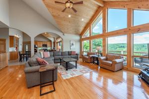 a living room with furniture and large windows at Rocky Mountain Lodge by Railey Vacations in McHenry