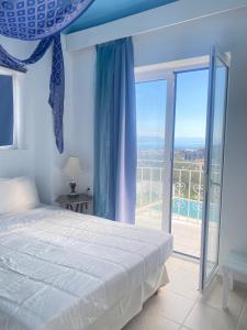 a bedroom with a bed and a large window at Corfu Olive Village with Swimming Pool Castello Di Vista in Análipsis +190 photos