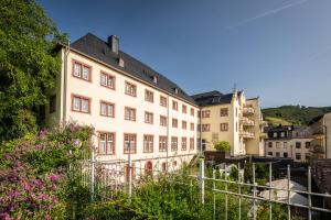 a building with flowers in front of it at Schloß-Hotel Petry in Treis-Karden