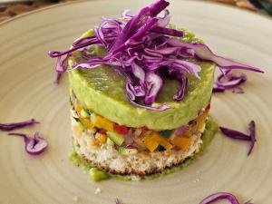 a white plate with a sandwich with vegetables on it at Kampasi Olmoingo Camp in Talek
