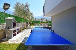 two blue ping pong tables in a backyard at Villa Olivin in Fethiye