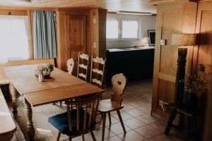 a dining room with a wooden table and chairs at 4 bedroom house for 8 guests in Brülisau +30 photos