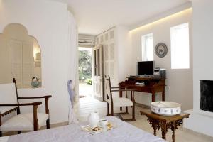 a living room with a table and a desk at Corfu Olive Village with Swimming Pool Castello Di Vista in Análipsis