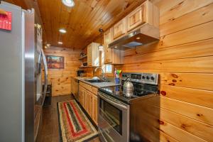 a kitchen with a stove and a sink at Cozy Cub Cabin by Railey Vacations in McHenry