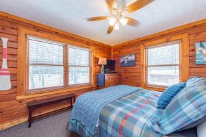 a bedroom with a bed and a ceiling fan at Crows Nest by Railey Vacations in Swanton
