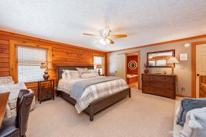 a bedroom with a bed and a ceiling fan at Crows Nest by Railey Vacations in Swanton +47 photos