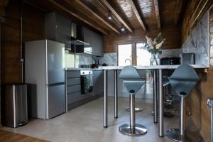 a kitchen with stainless steel appliances and a counter with stools at Owls Nest in Larling