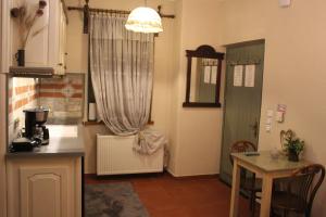 a kitchen with a table and a window and a table at Arachova Boka's House, Elegant Apartment in Arachova +15 photos