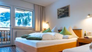 a bedroom with a large bed with pillows on it at Haus Ladner in See