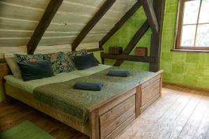a bedroom with a large bed in a room with green walls at Zezuj Agroturystyka i Łowisko in Zezuj
