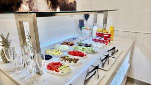 a buffet with several dishes of food on a counter at Diamante Paguera Boutique Hotel in Paguera
