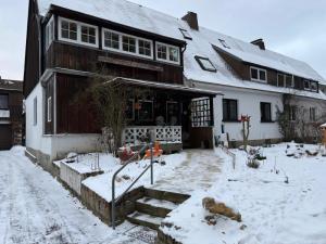 a house with snow on the ground in front of it at Fichtenblick in Selb
