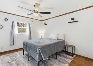 a bedroom with a bed and a ceiling fan at Lakeside Brick Retreat For 8 in Branson West