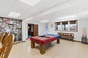 a room with a table and a rock wall at Lakeside Brick Retreat For 8 in Branson West