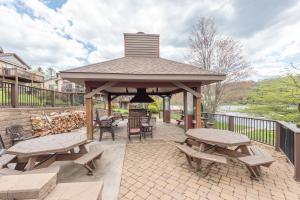 a gazebo with benches and tables on a patio at DC Love Shack by Railey Vacations in McHenry